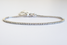Load image into Gallery viewer, 1.5 Carat Diamond Tennis Bracelet in white gold laid flat in a circle on a white background.
