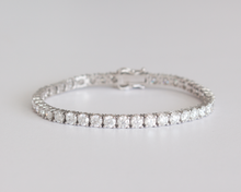 Load image into Gallery viewer, 10 Carat Diamond Tennis Bracelet in white gold laid flat in a circle on a white background.
