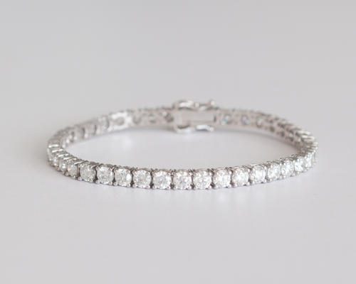 10 Carat Diamond Tennis Bracelet in white gold laid flat in a circle on a white background.