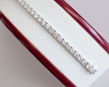Load image into Gallery viewer, 10 Carat Diamond Tennis Bracelet in white gold laid flat in a box on a white background.
