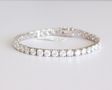 Load image into Gallery viewer, 13 Carat Diamond Tennis Bracelet in white gold laid flat in a circle on a white background.
