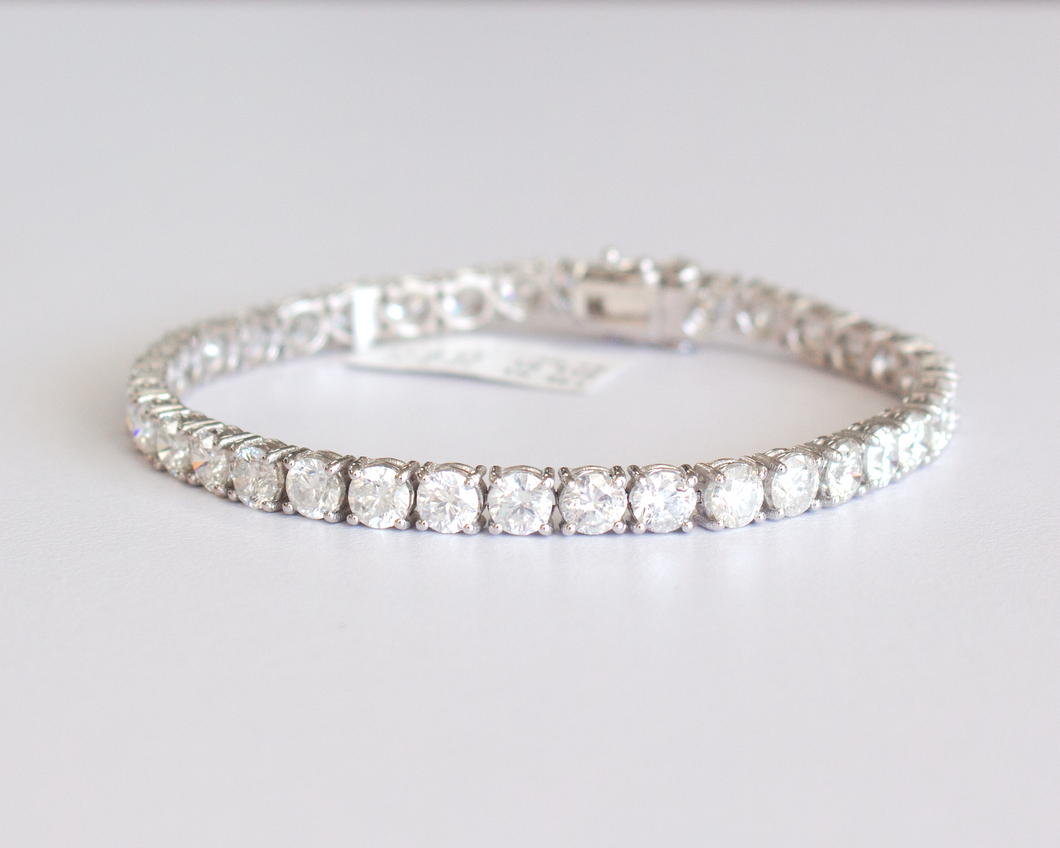 13 Carat Diamond Tennis Bracelet in white gold laid flat in a circle on a white background.