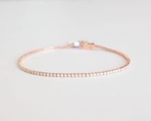 Load image into Gallery viewer, 1 carat diamond tennis bracelet in rose gold laid in a circle, clasped, on a white background.
