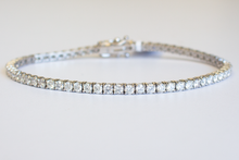 Load image into Gallery viewer, 4 Carat Diamond Tennis Bracelet in white gold laid flat in a circle on a white background.
