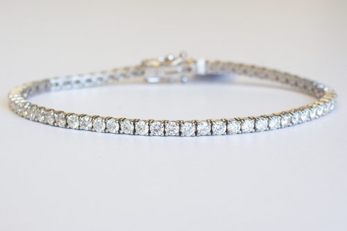 4 Carat Diamond Tennis Bracelet in white gold laid flat in a circle on a white background.