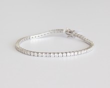 Load image into Gallery viewer, 5 Carat Diamond Tennis Bracelet in white gold laid flat in a circle on a white background.
