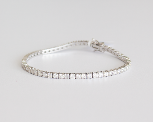 5 Carat Diamond Tennis Bracelet in white gold laid flat in a circle on a white background.