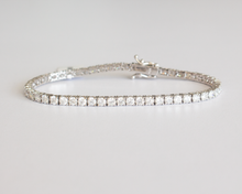 Load image into Gallery viewer, 6 Carat Diamond Tennis Bracelet in white gold laid flat in a circle on a white background.
