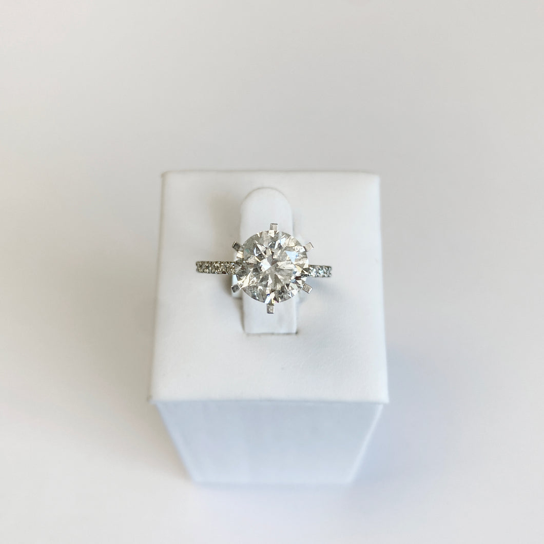 6 Prong Engagement Ring Setting with diamonds almost all the way around in white gold displayed on a white background.