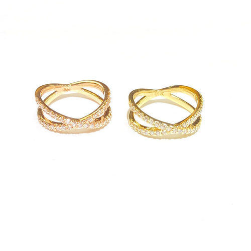 Two Diamond Criss Cross Ring in 14k  rose and yellow Gold laid flat on a white background.