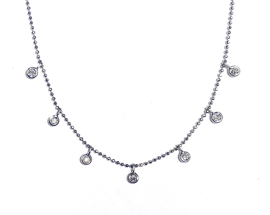 Diamond Dangle necklace in 14k white gold laid flat on a white background.