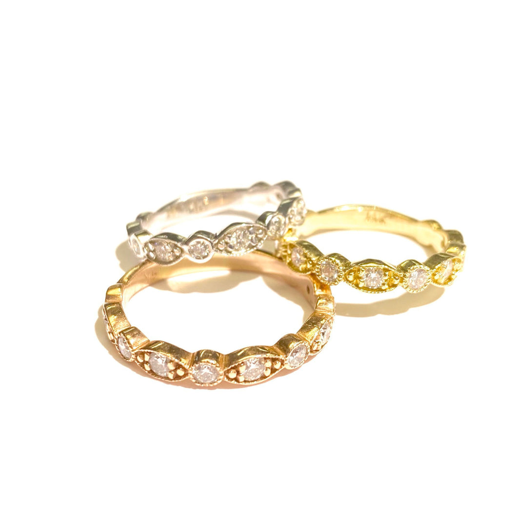 Three Diamond Deco Stackable Ring in 14k rose, yellow and white Gold loosely stacked on a white background.
