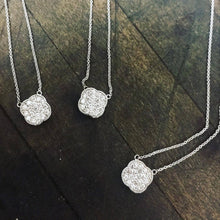 Load image into Gallery viewer, Three Diamond Lucky Four Leaf Clover necklaces in 14k white gold laid flat on a wooden background.
