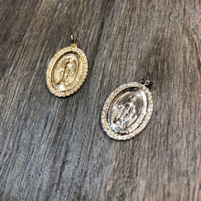 Load image into Gallery viewer, Two Diamond Mini Mary Medallion in 14k white and yellow gold laid flat on a wooden background.
