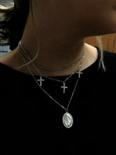 Load image into Gallery viewer, Diamond Mini Mary Medallion necklace in 14k white gold hanging a person&#39;s neck against a black blouse.
