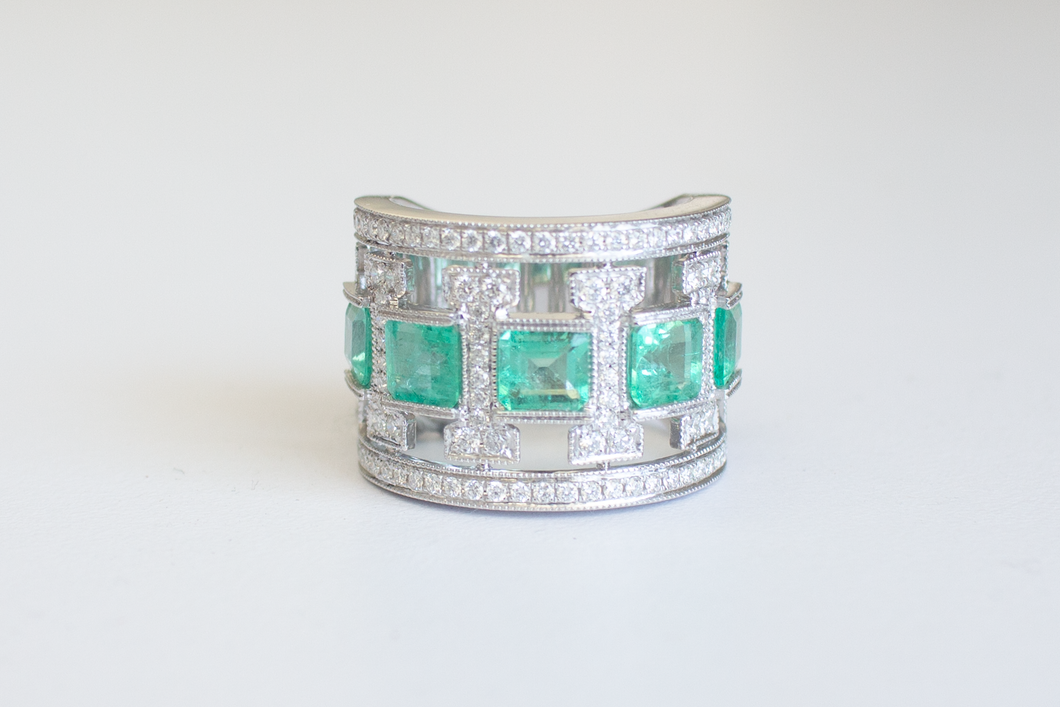 Straight on view of an Emerald Art Deco Band in 18k white gold on a white background.