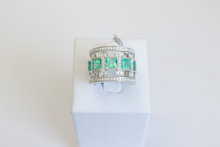 Load image into Gallery viewer, Straight on view of an Emerald Art Deco Band in 18k white gold on a ring stand on a white background.

