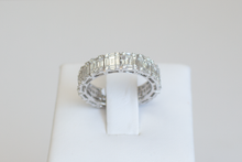 Load image into Gallery viewer, Straight on view Emerald Cut Diamond Illusion Band on a ring stand a white background.
