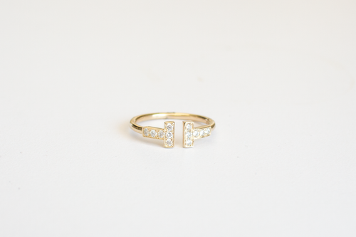 Miss Tiff Ring in 14k Yellow Gold and Diamonds laid flat on a white background.