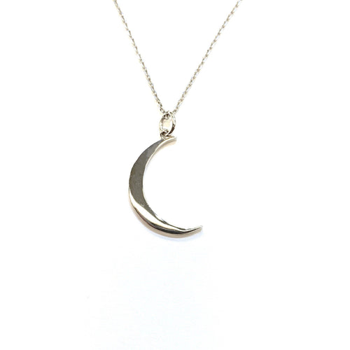 Moon Pendant in 14K Gold laid flat on a white background.