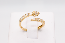 Load image into Gallery viewer, Snake Wrap Gold Ring with Baguette Diamonds on a ring holder against a white background.
