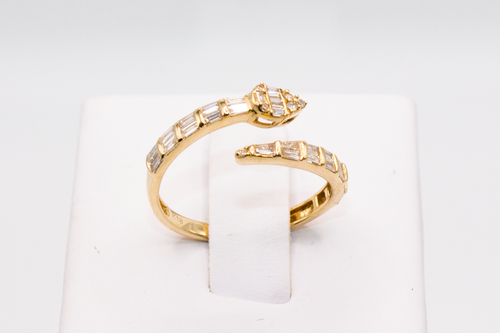 Snake Wrap Gold Ring with Baguette Diamonds on a ring holder against a white background.