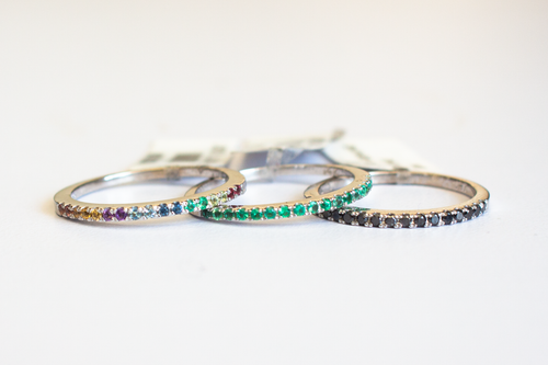 Three 14k White Gold Half Eternity Bands with multi-colored, green, and black gems on a white background.